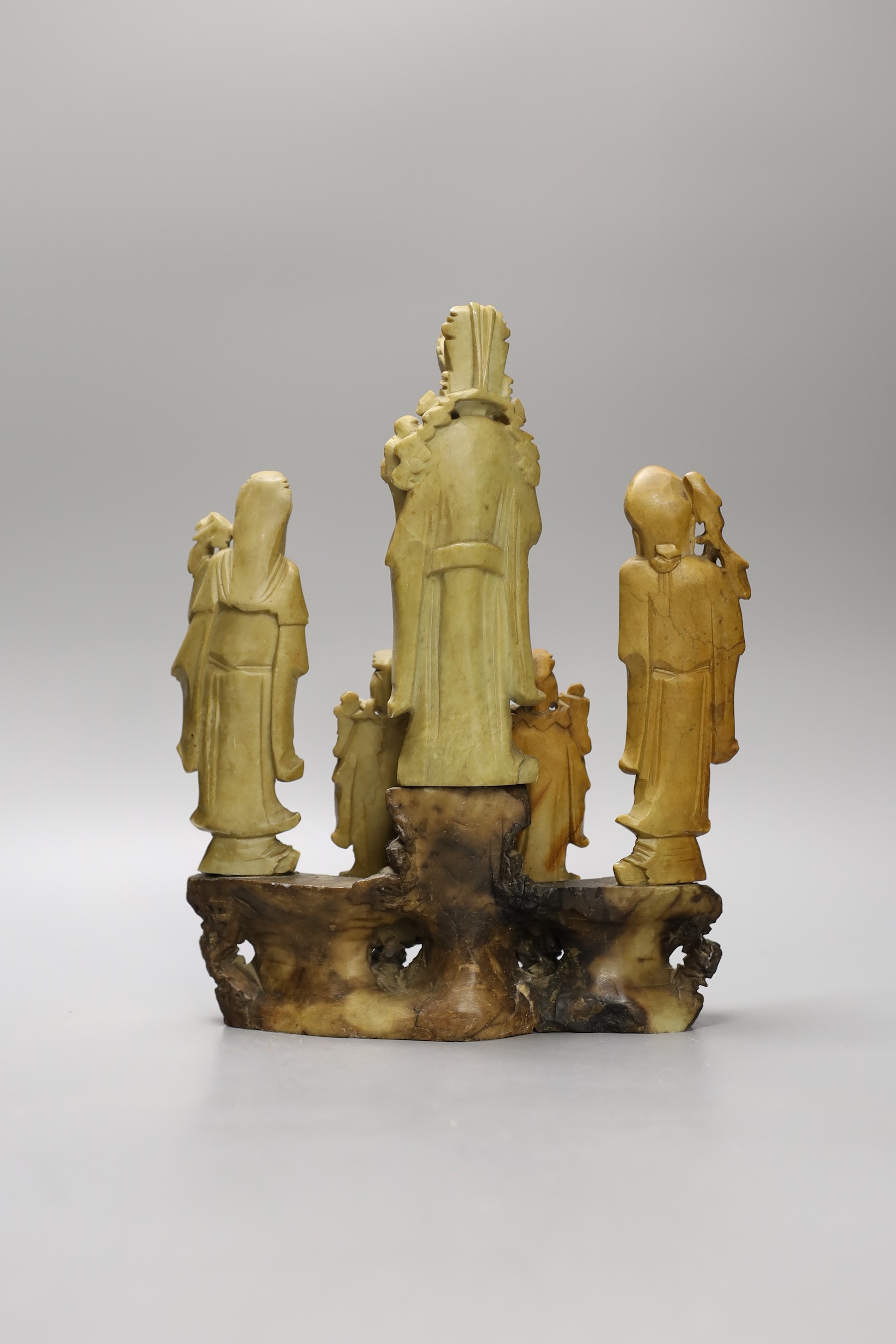A Chinese soapstone five immortals group on graduated base, 28cm tall